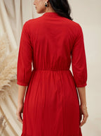Red dress worn by a person with a neutral background