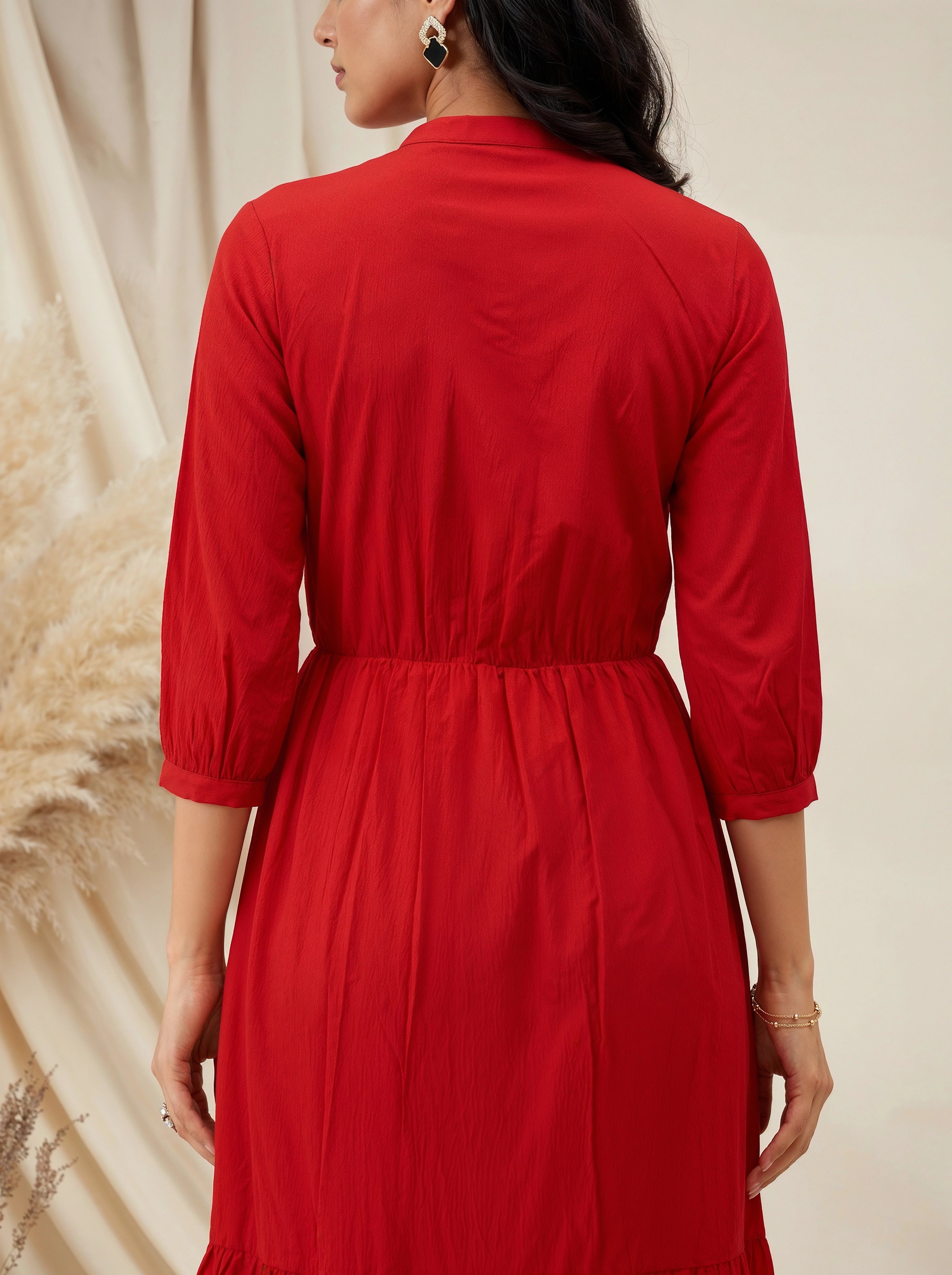 Red dress worn by a person with a neutral background