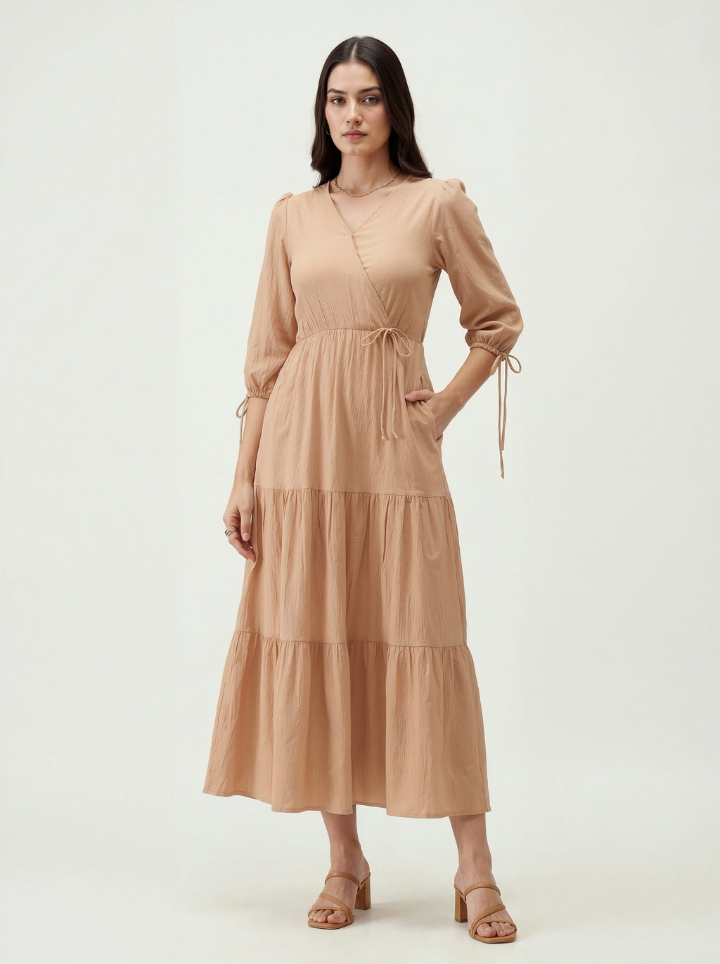 Woman wearing a beige dress on a white background