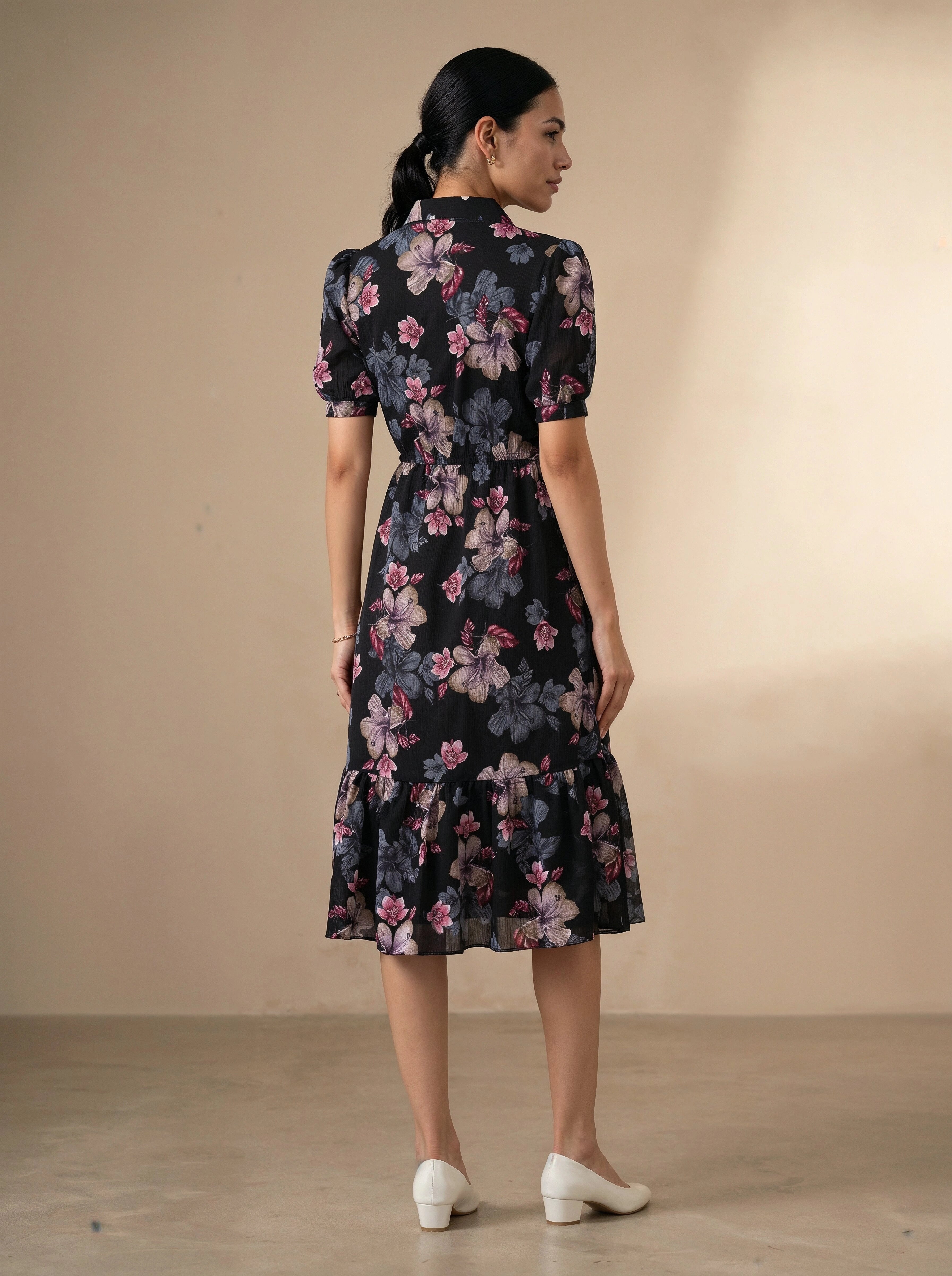 Woman wearing a floral dress against a beige background