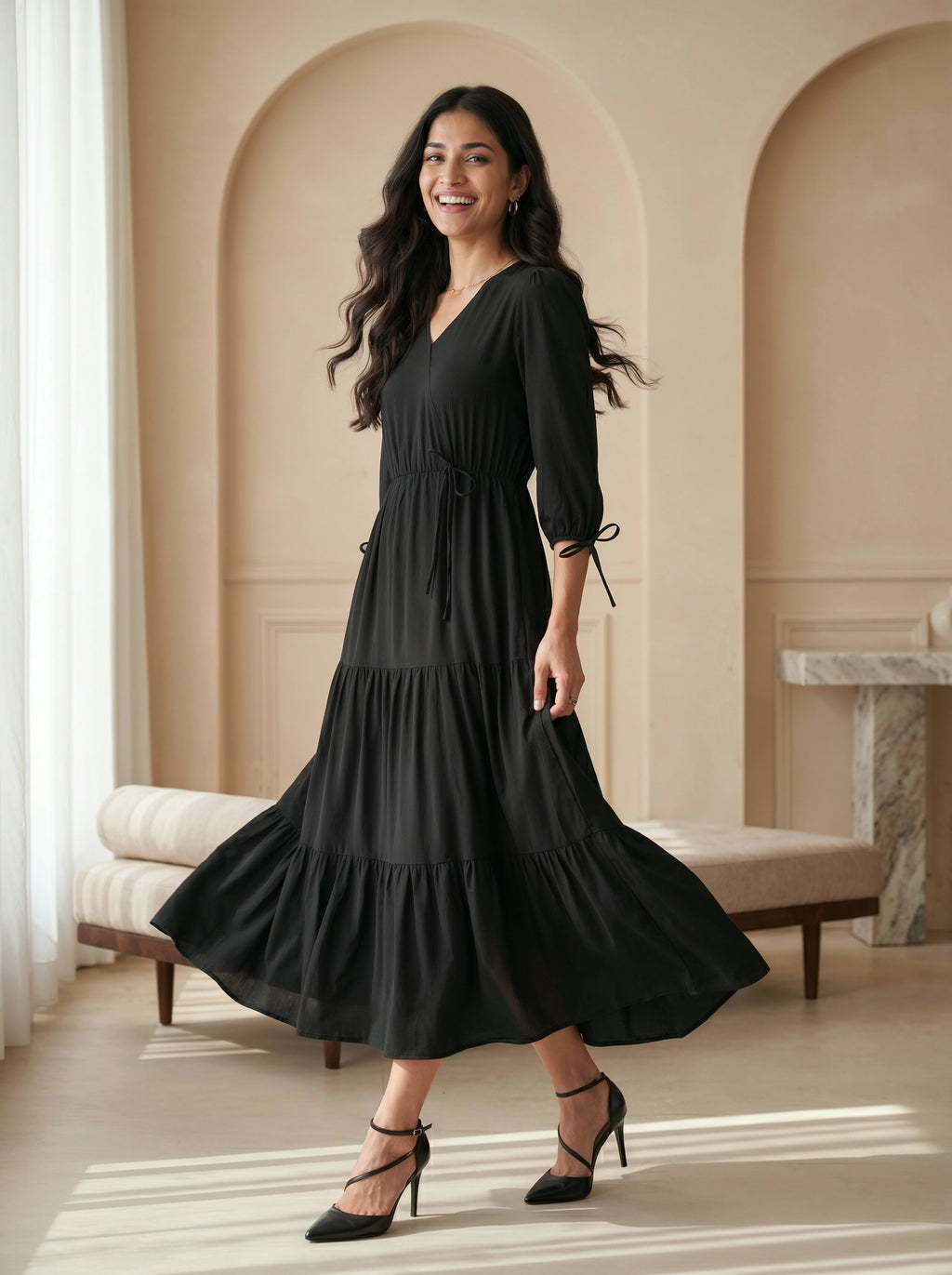Woman wearing a black dress standing in a stylish interior setting