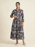 Woman wearing a patterned dress on a beige background