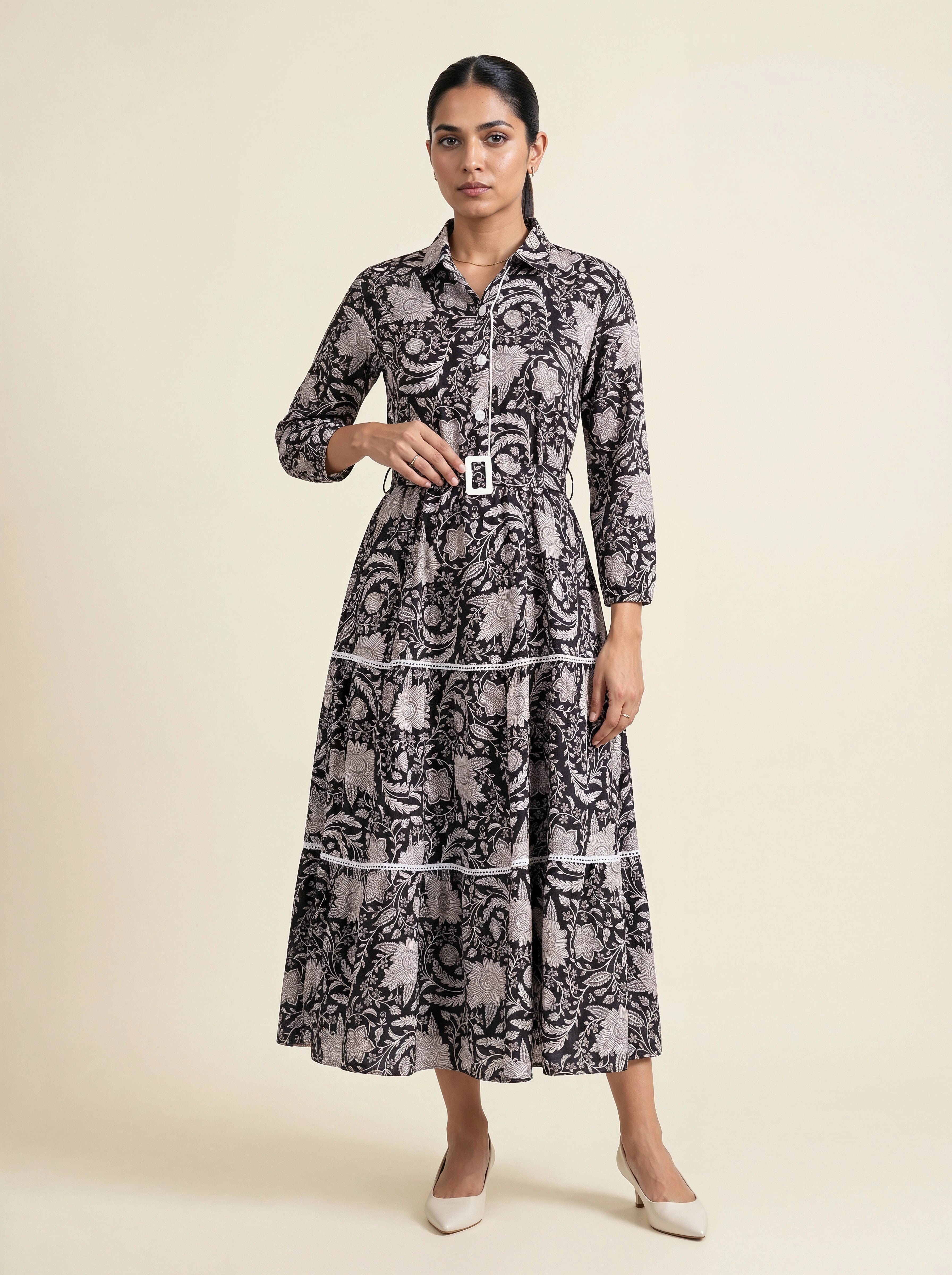Woman wearing a patterned dress on a beige background