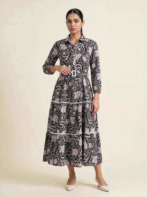 Woman wearing a patterned dress on a beige background