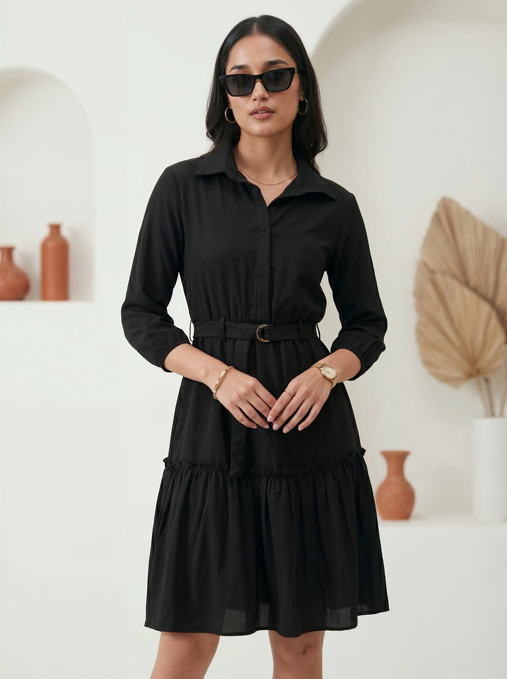 Woman wearing a black dress with a white background