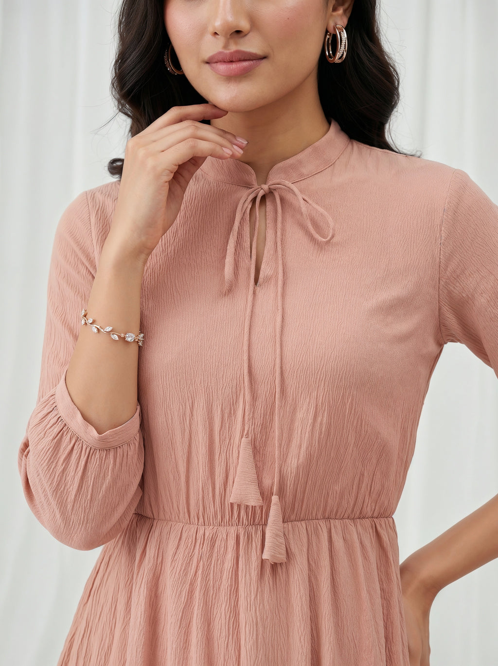 Woman wearing a pink dress with a white background