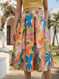 Person wearing a colorful floral skirt with a blurred outdoor background