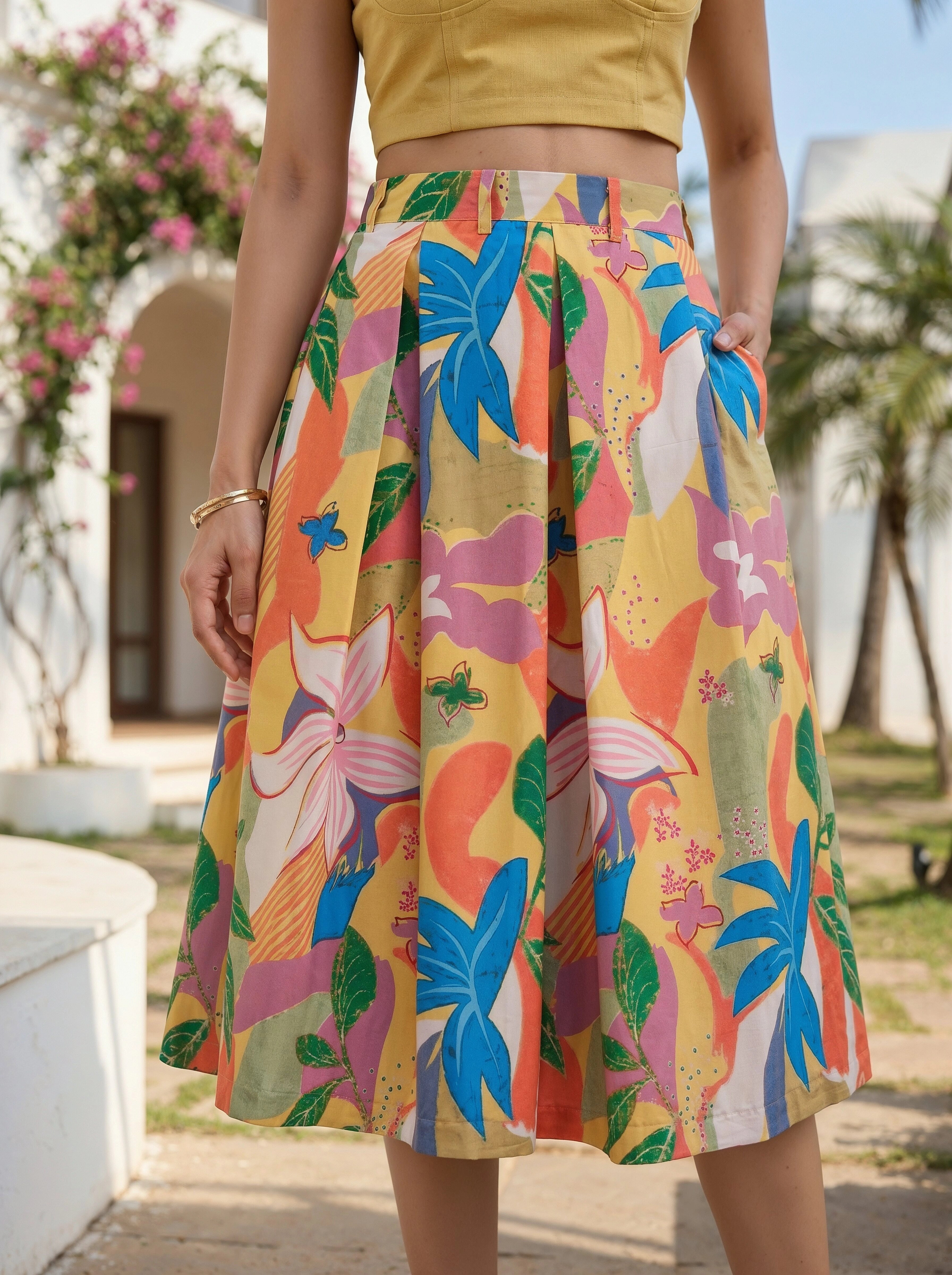 Person wearing a colorful floral skirt with a blurred outdoor background