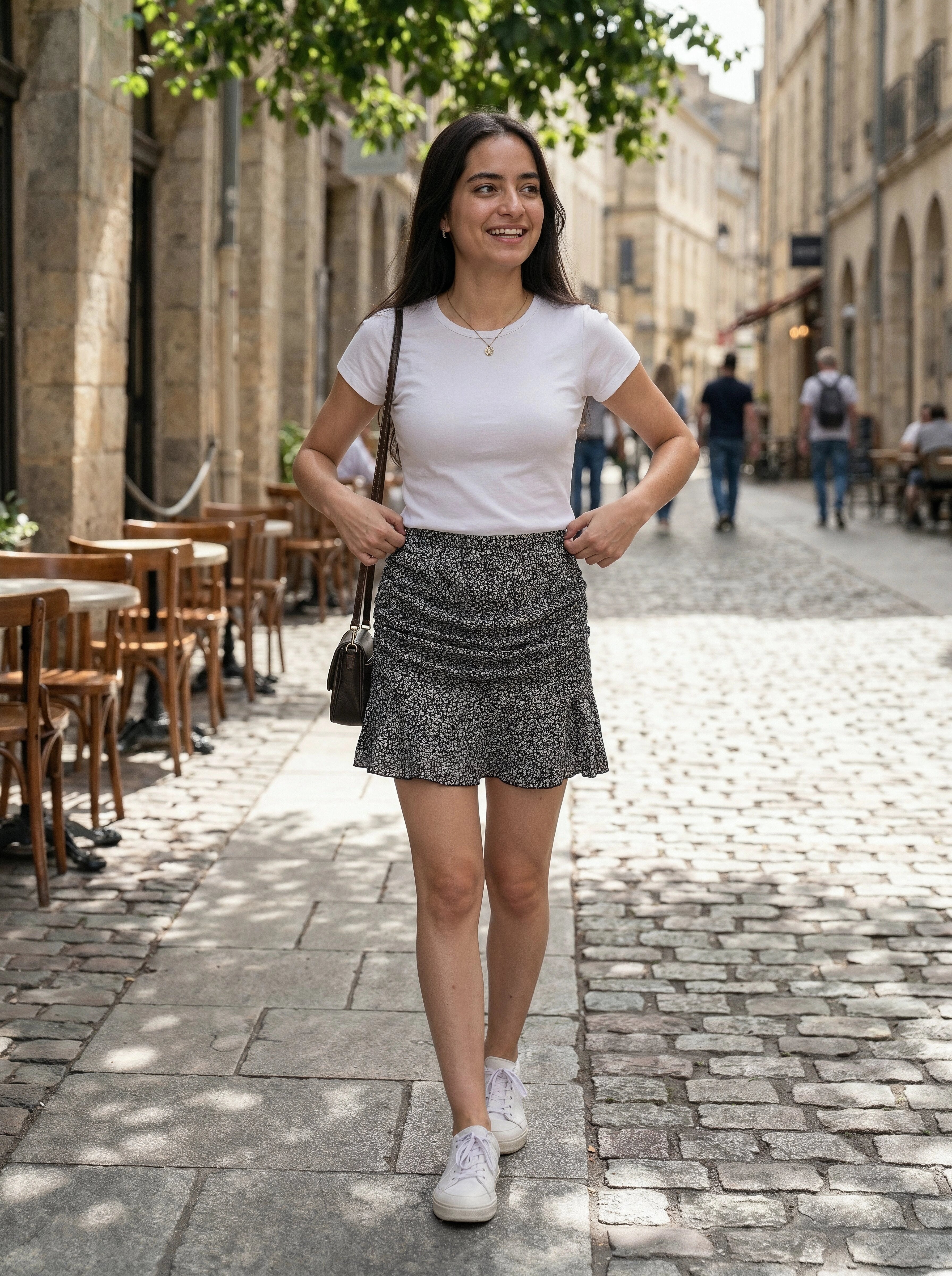 Woman walking on a cobbled street in an urban setting