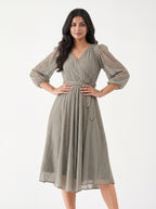 Woman wearing a patterned dress on a white background