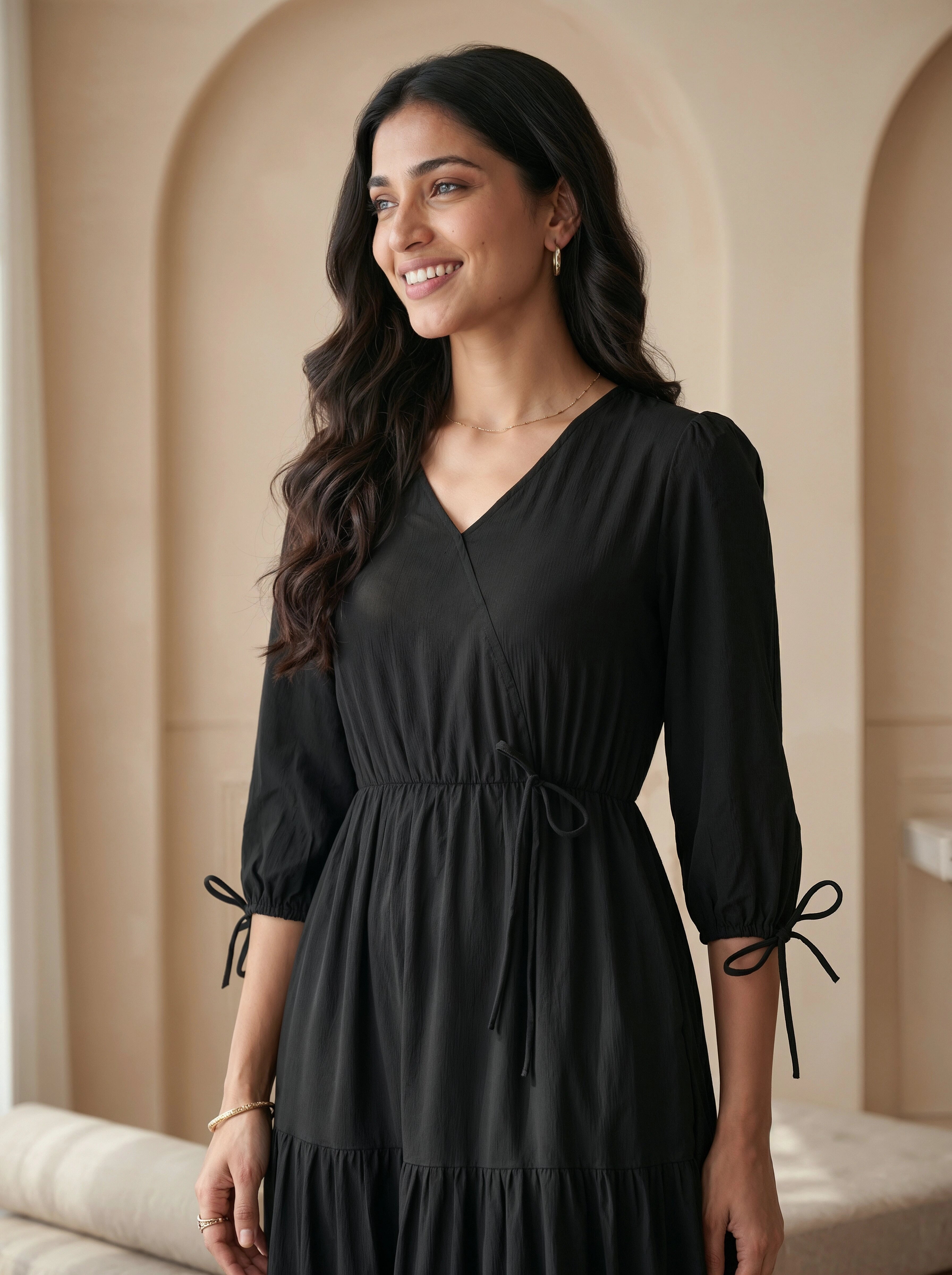 Woman wearing a black dress with a beige wall background