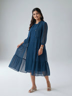 Woman wearing a blue dress with a white background