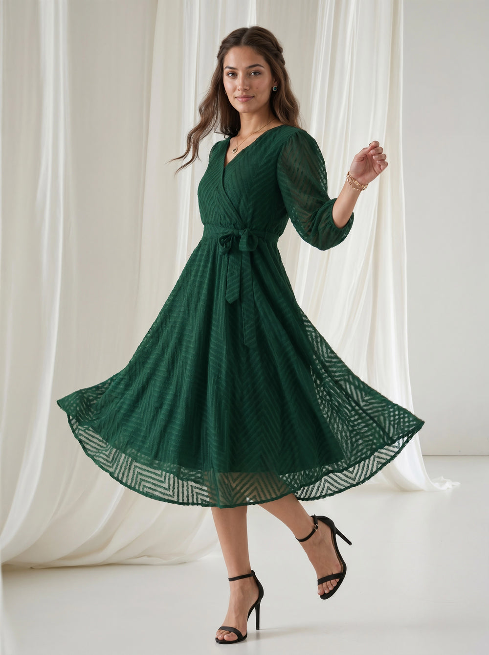 Woman wearing a green dress with a white curtain background