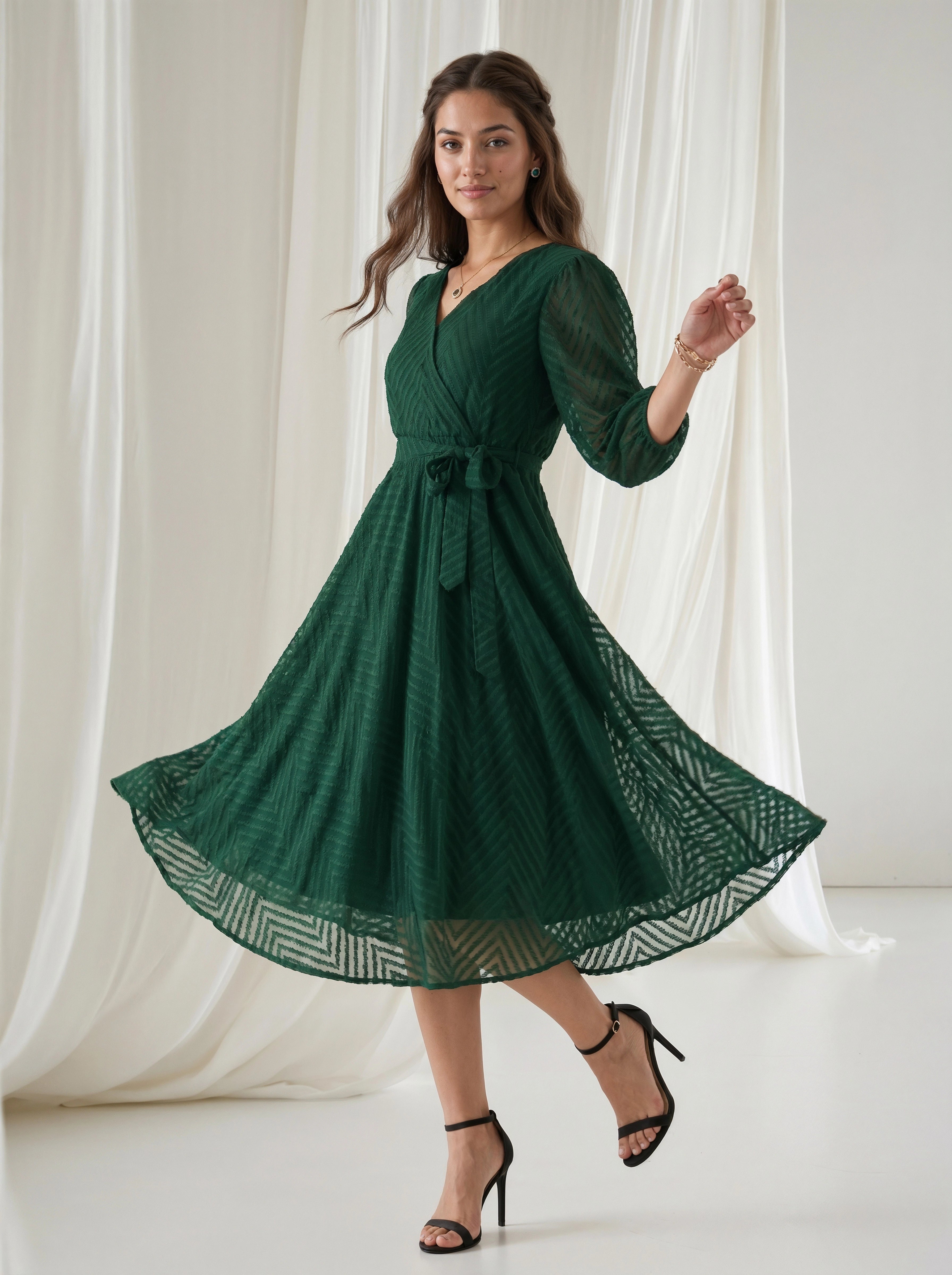 Woman wearing a green dress with a white curtain background