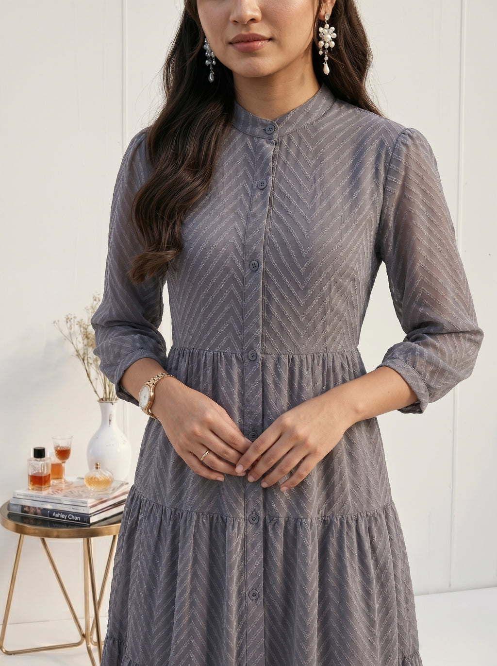 Woman wearing a gray dress with a blurred background
