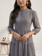 Woman wearing a gray dress with a blurred background
