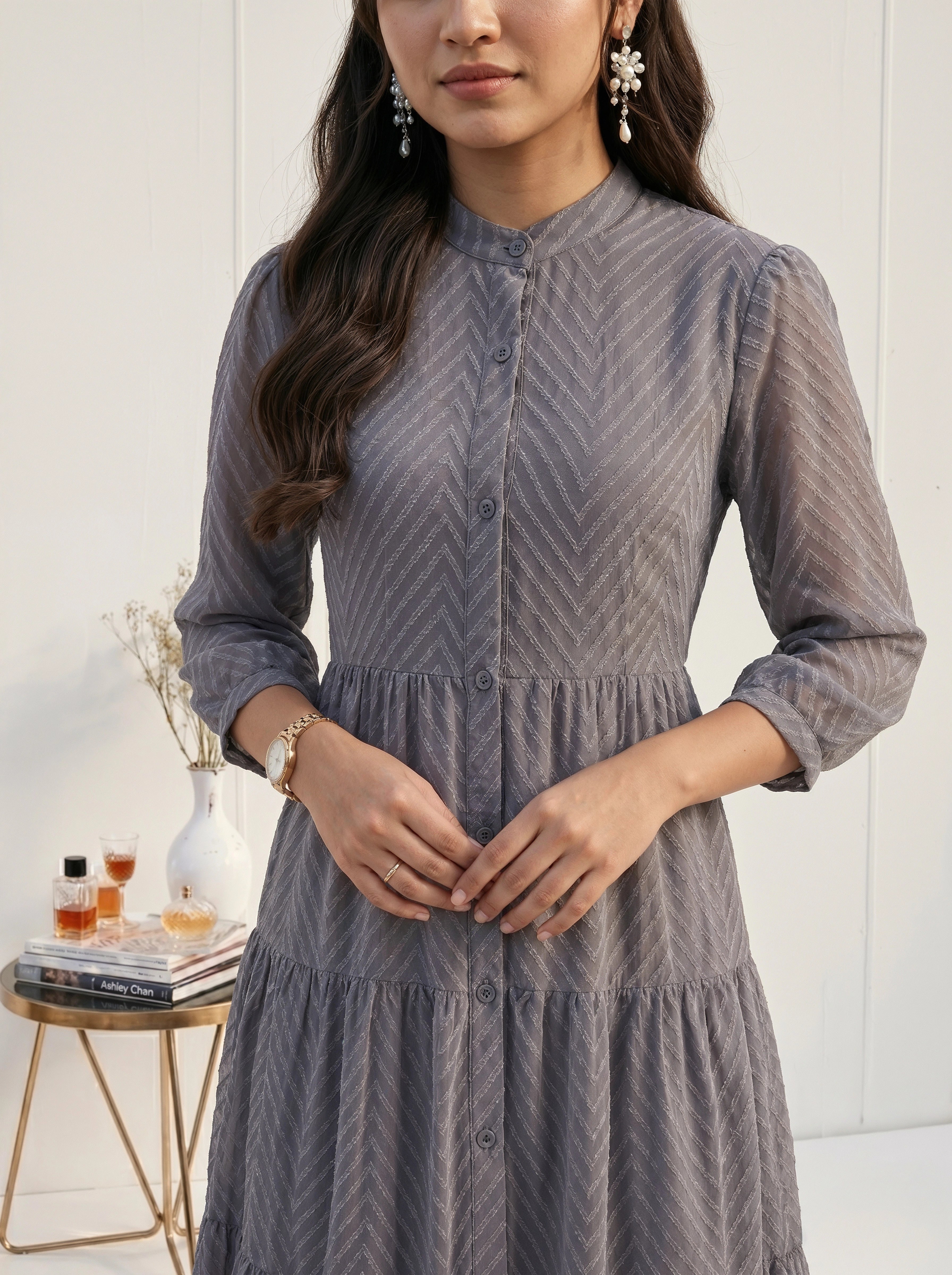 Woman wearing a gray dress with a blurred background
