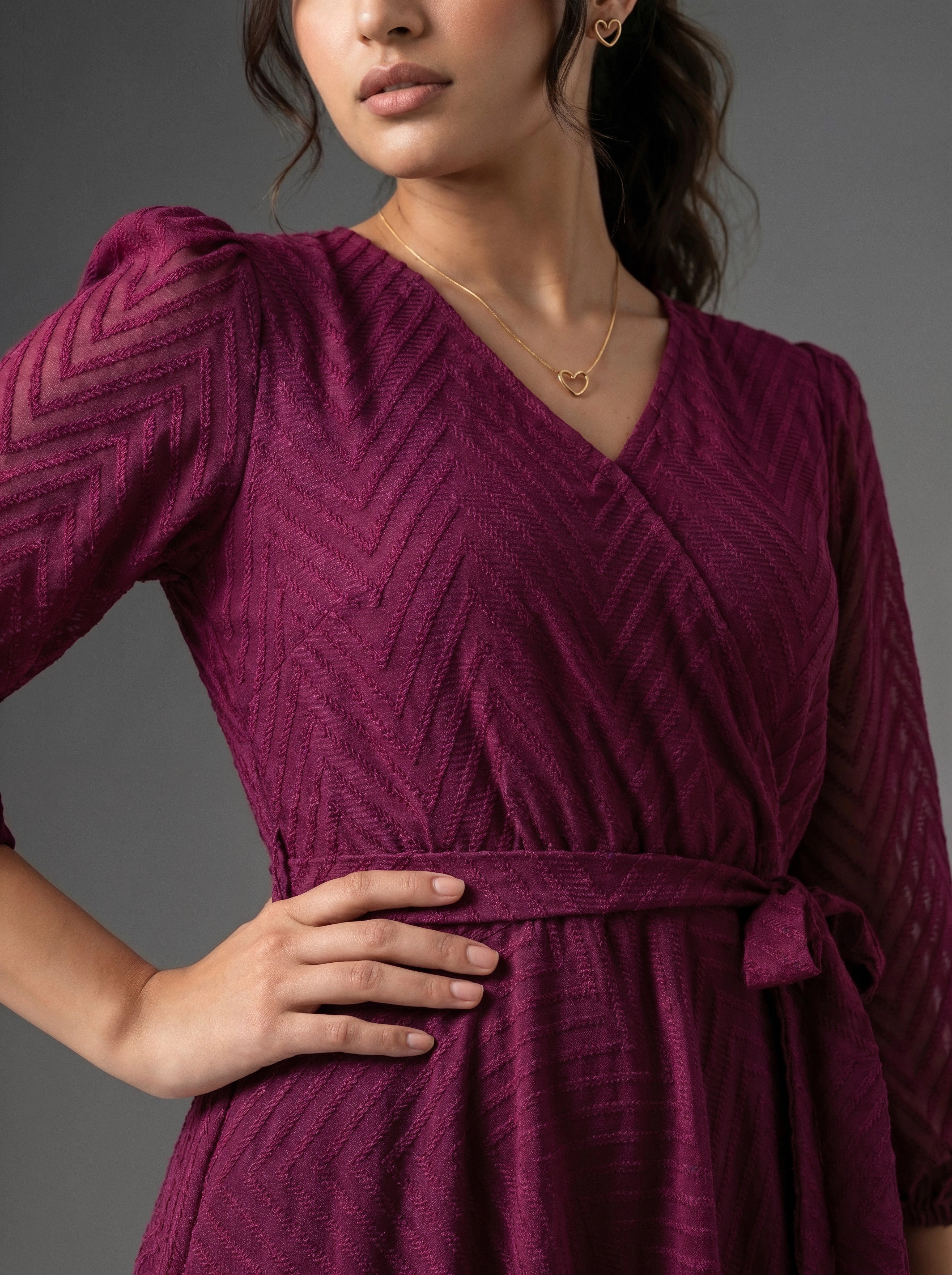 Woman wearing a purple dress with a gray background