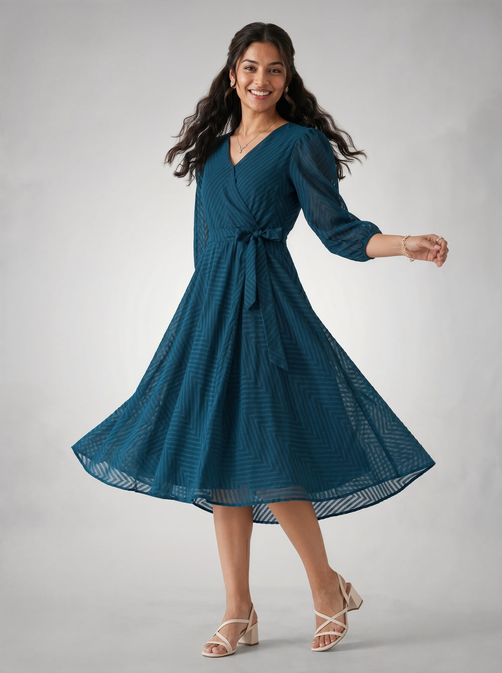 Woman wearing a blue dress on a gray background