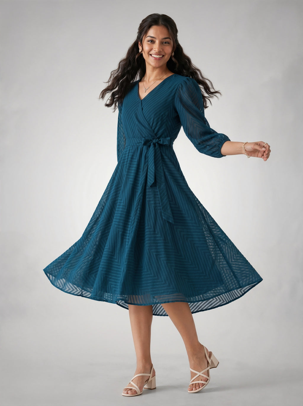 Woman wearing a blue dress on a gray background