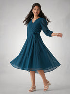 Woman wearing a blue dress on a gray background