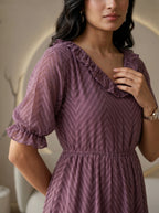 Woman wearing a black dress in a living room setting