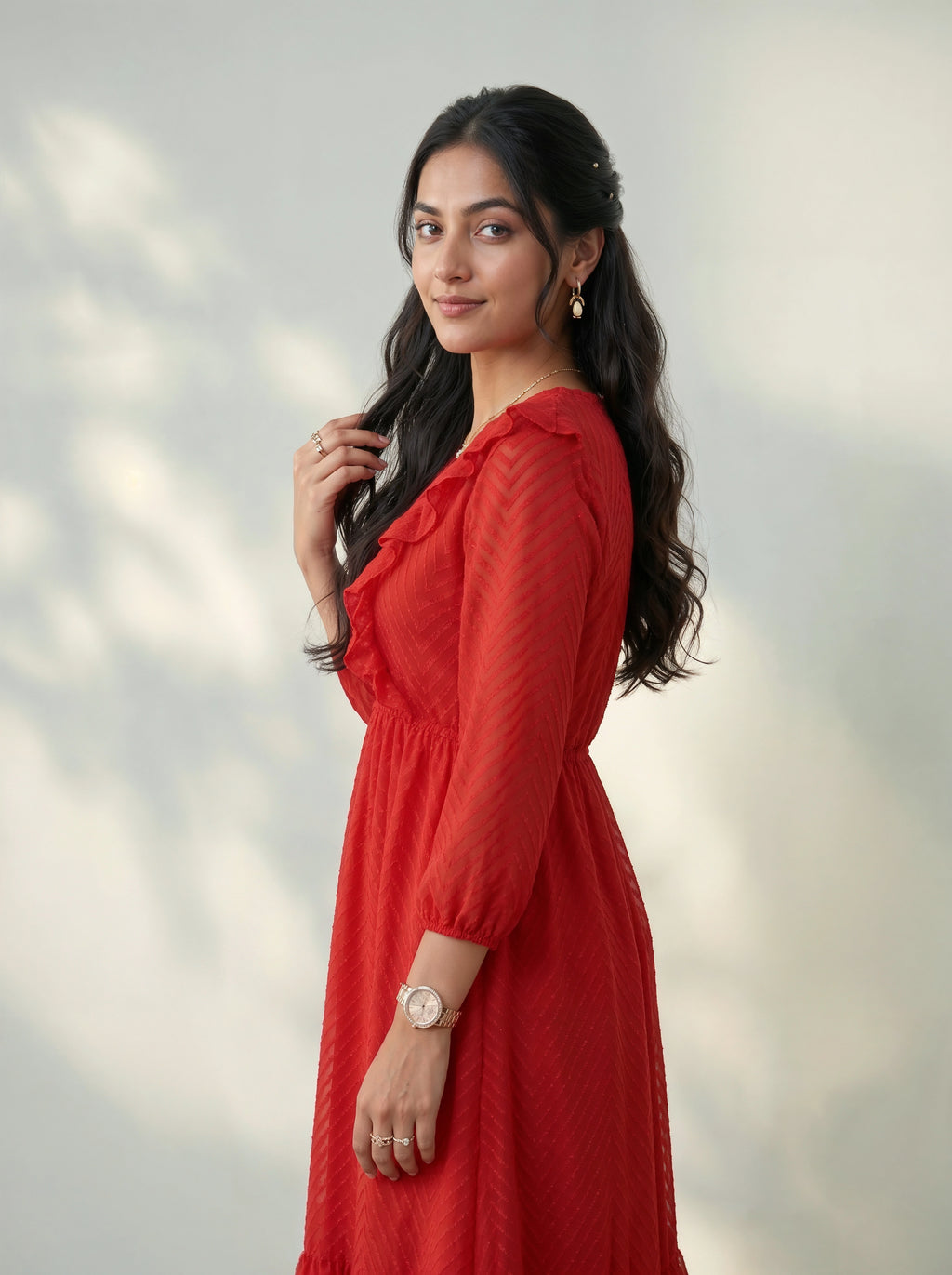 Woman in a red dress standing against a light background