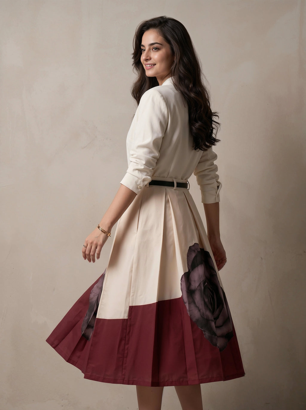 Woman wearing a white blouse and a two-tone skirt with a floral pattern on a beige background