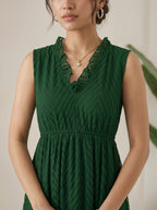 Woman wearing a green dress with a neutral background