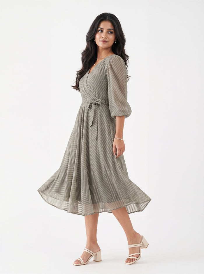Woman wearing a green patterned dress on a white background