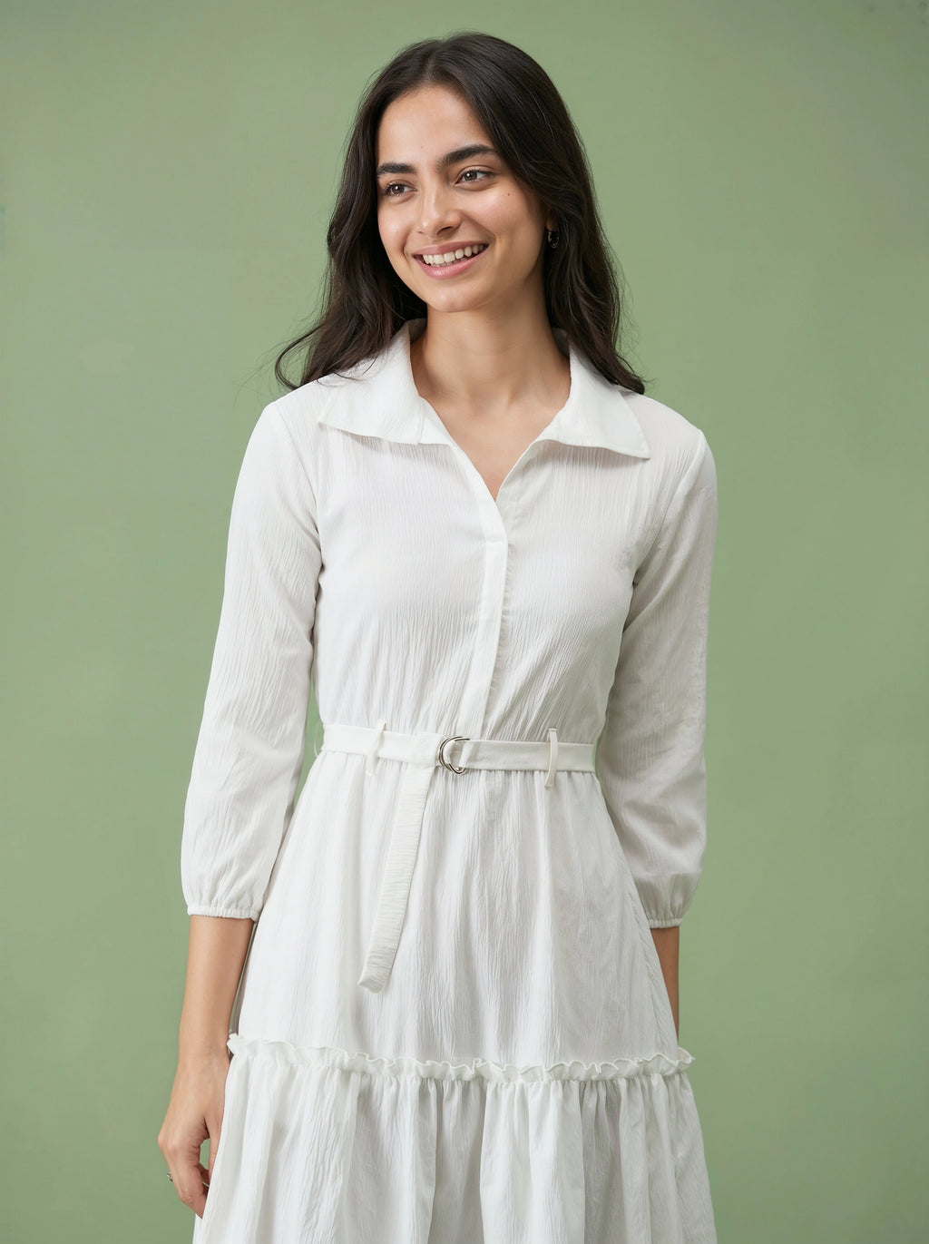 Woman wearing a white dress against a green background