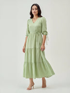 Woman wearing a light green dress on a white background