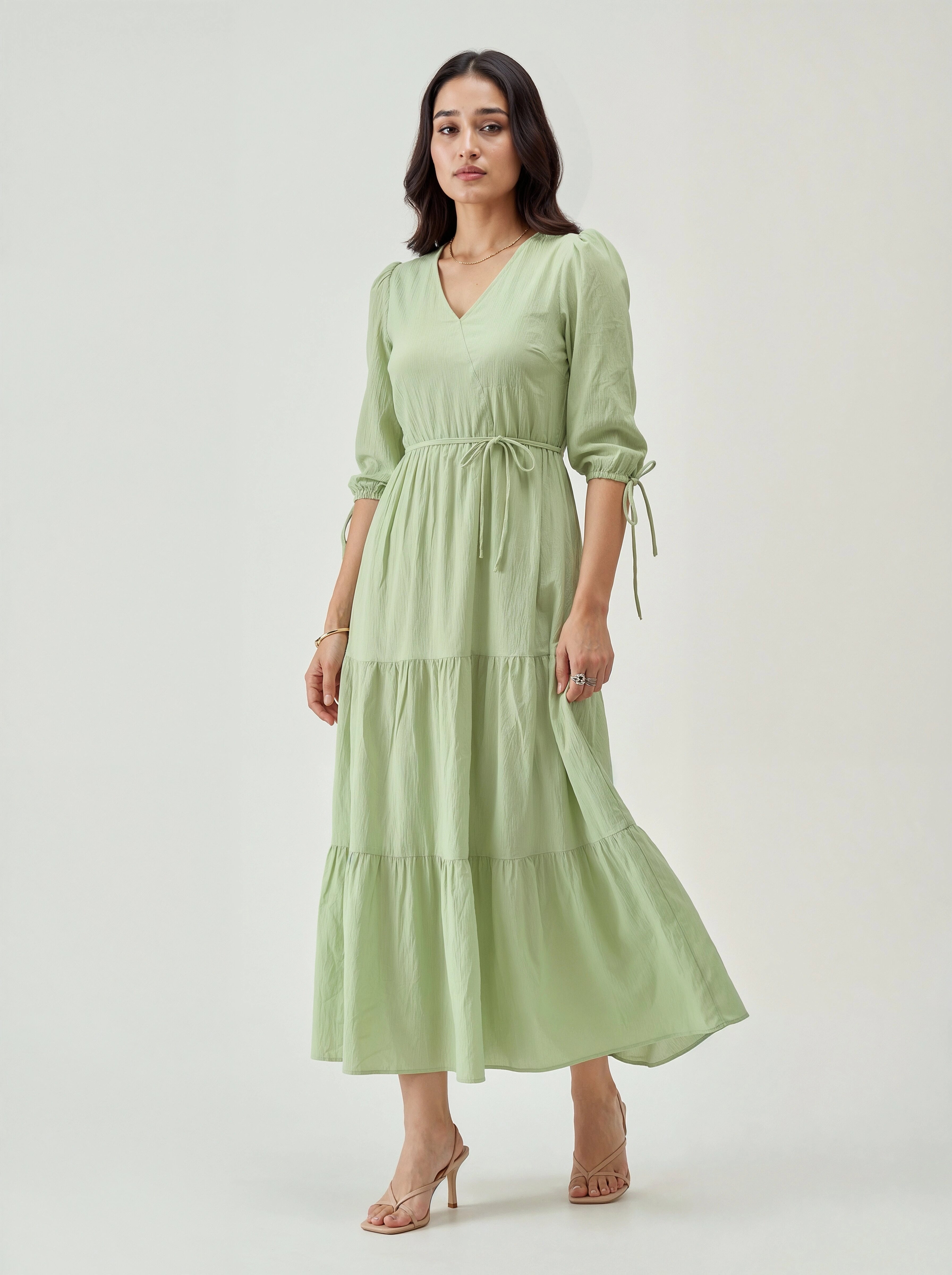 Woman wearing a light green dress on a white background