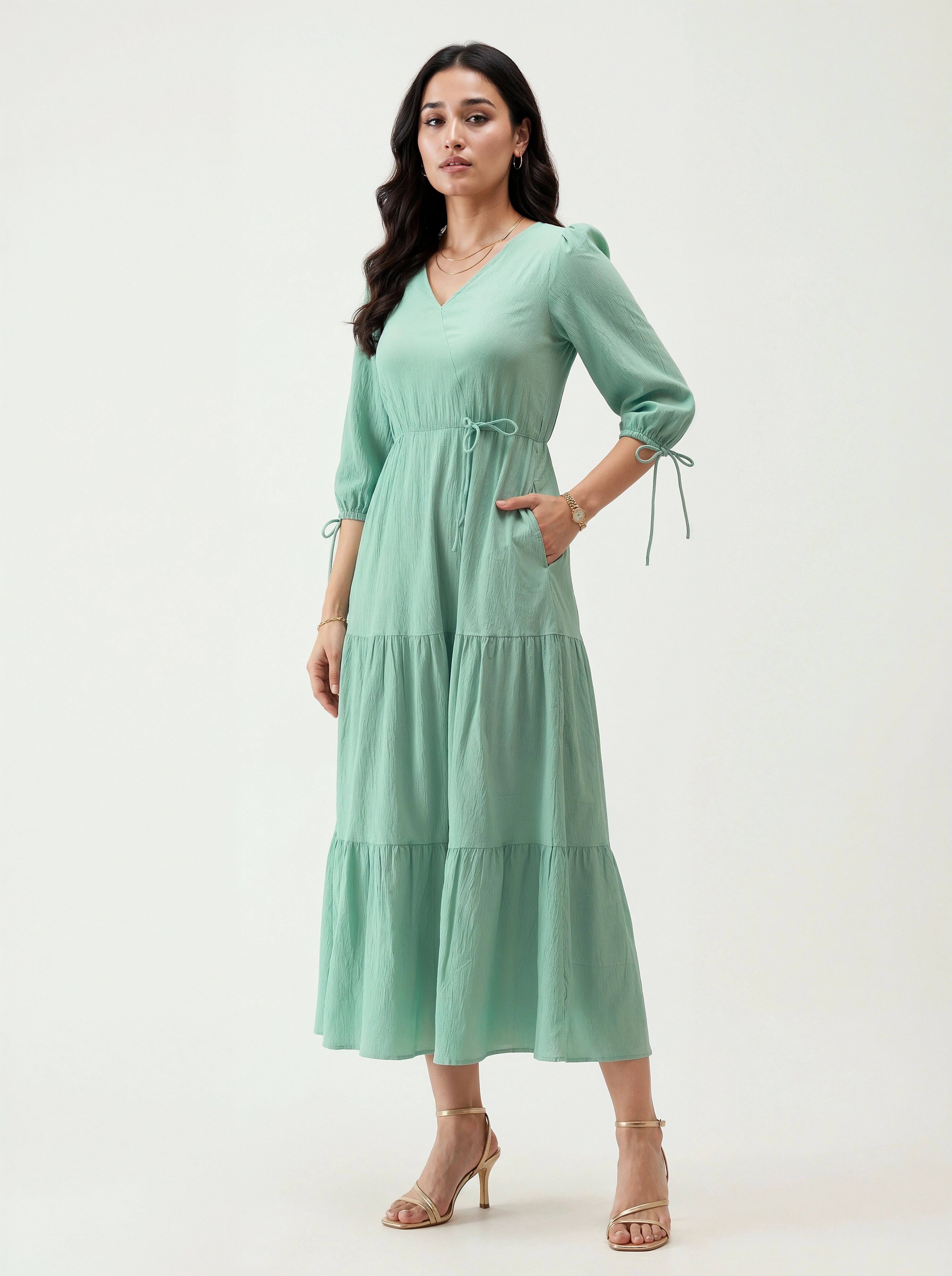 Woman wearing a light green dress on a white background