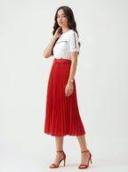 Elegant red pleated midi skirt and white t-shirt outfit styled with red high heel sandals.