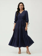 Woman wearing a navy blue dress on a white background