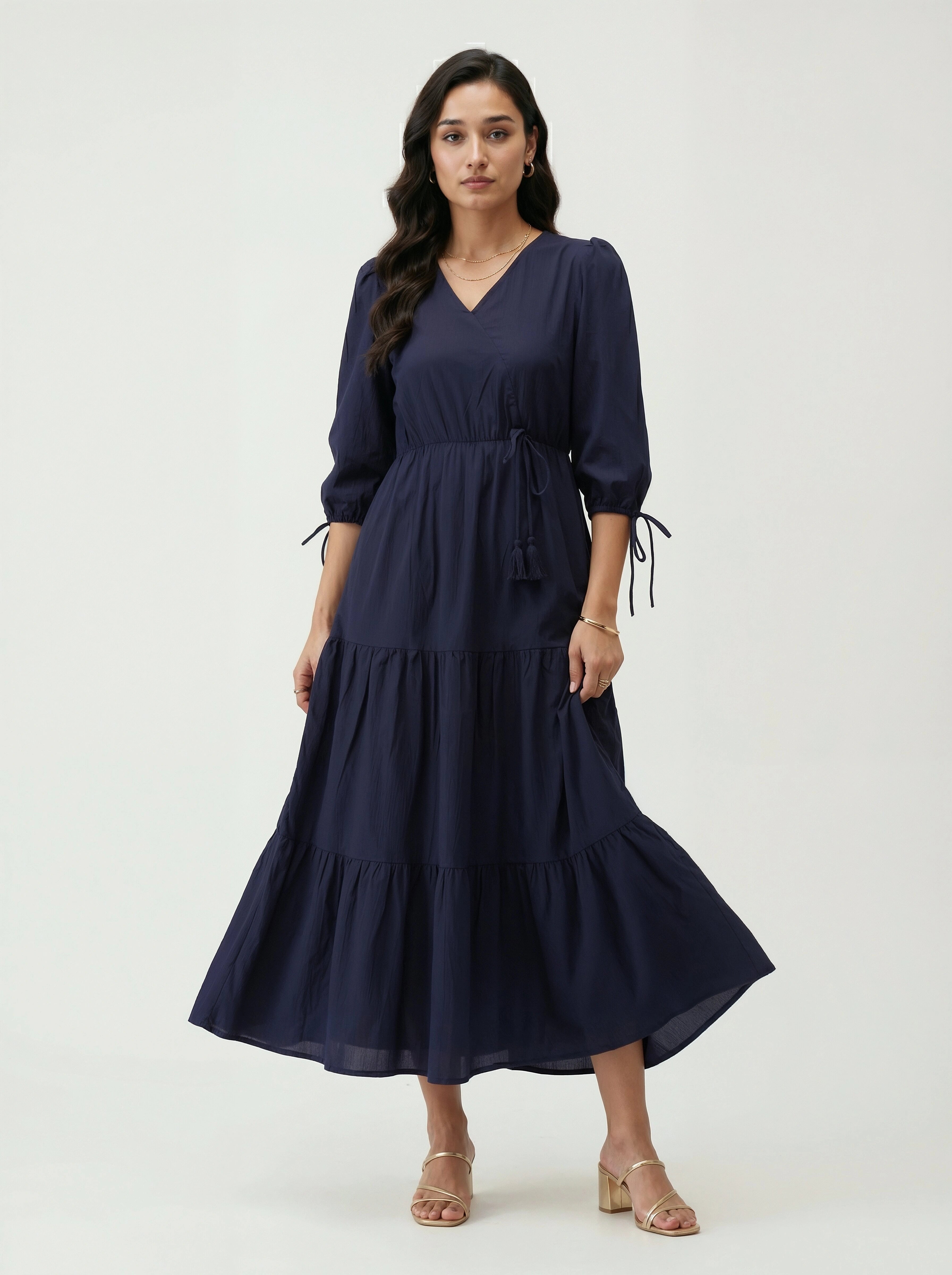 Woman wearing a navy blue dress on a white background