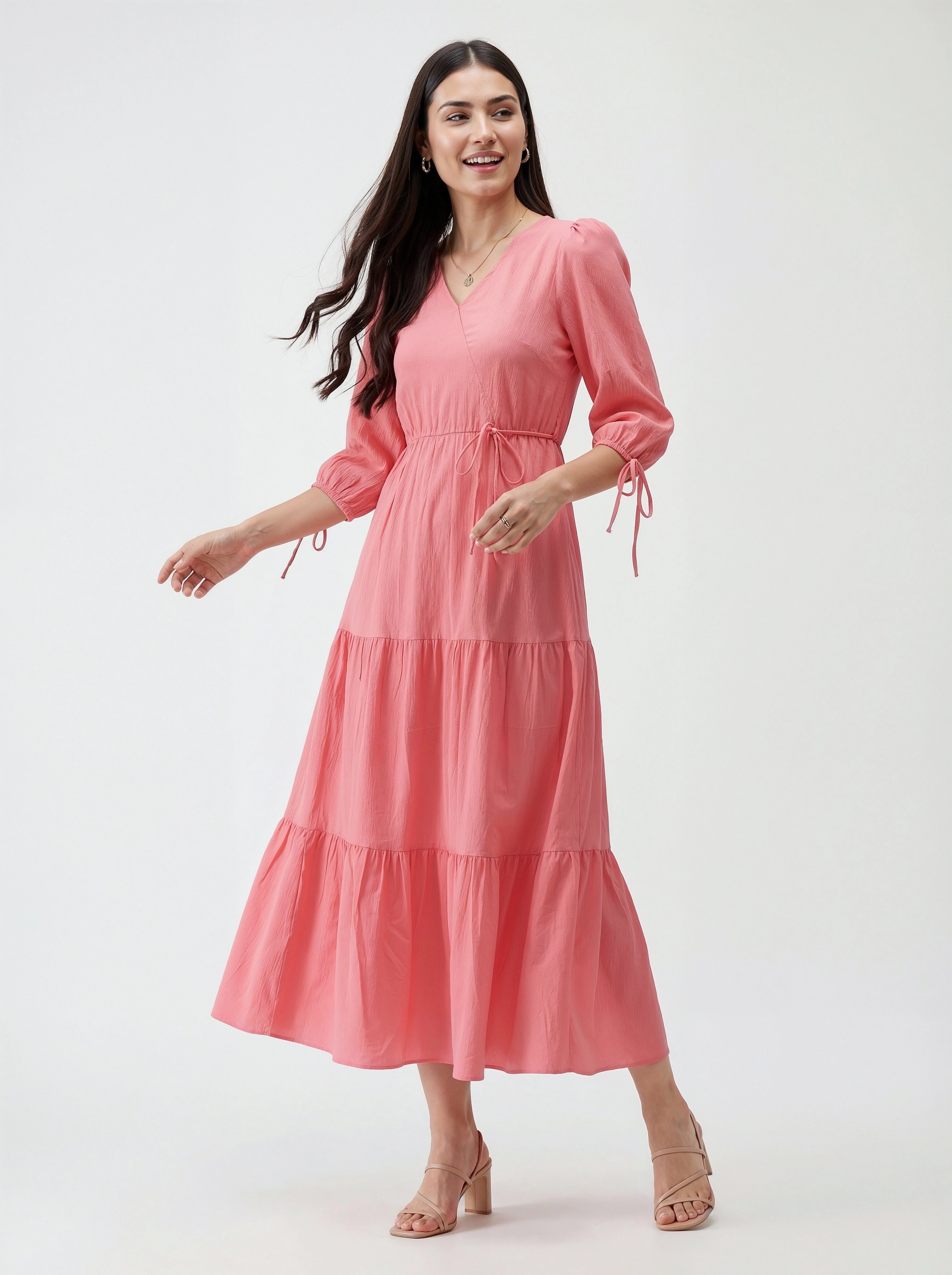 Woman wearing a pink dress on a white background
