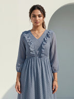 Woman wearing a blue dress with a white background