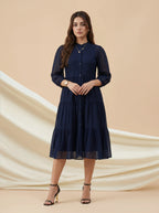 Woman wearing a navy blue dress on a beige background