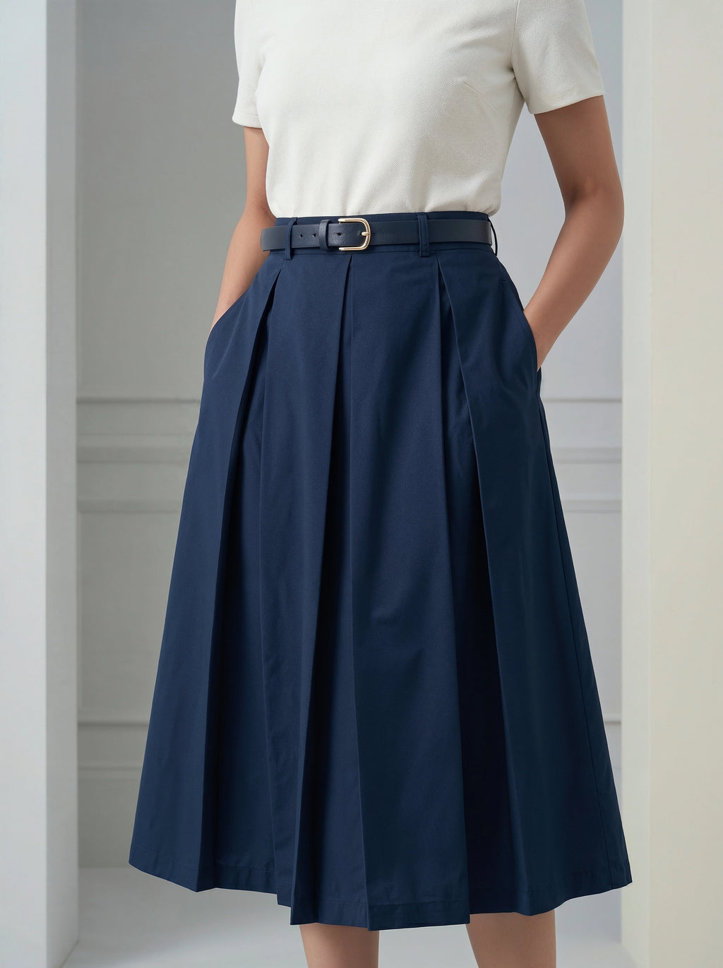 Navy blue skirt worn by a person against a neutral background
