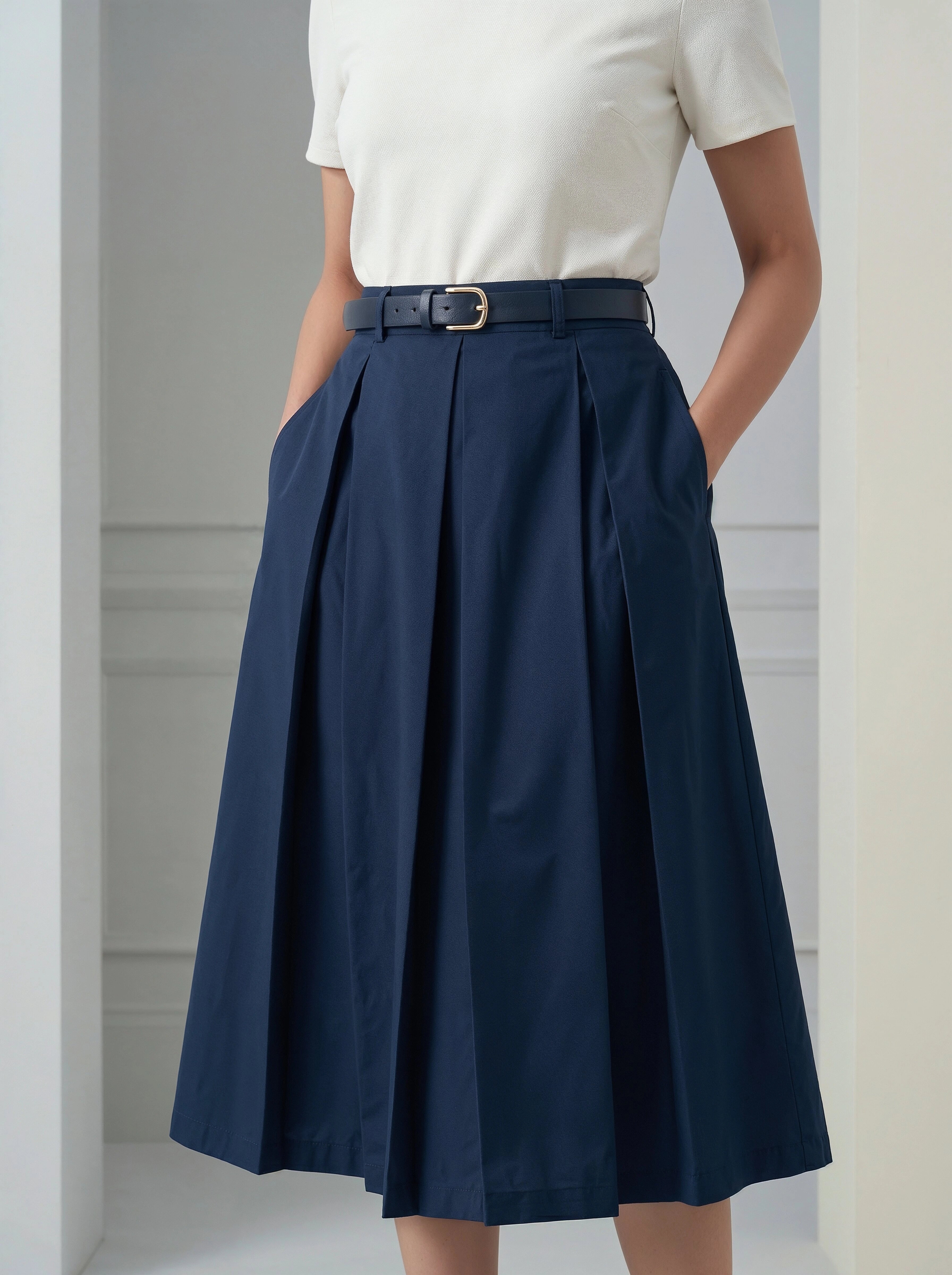 Navy blue skirt worn by a person against a neutral background