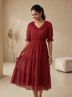 Woman wearing a red dress in a minimalistic room