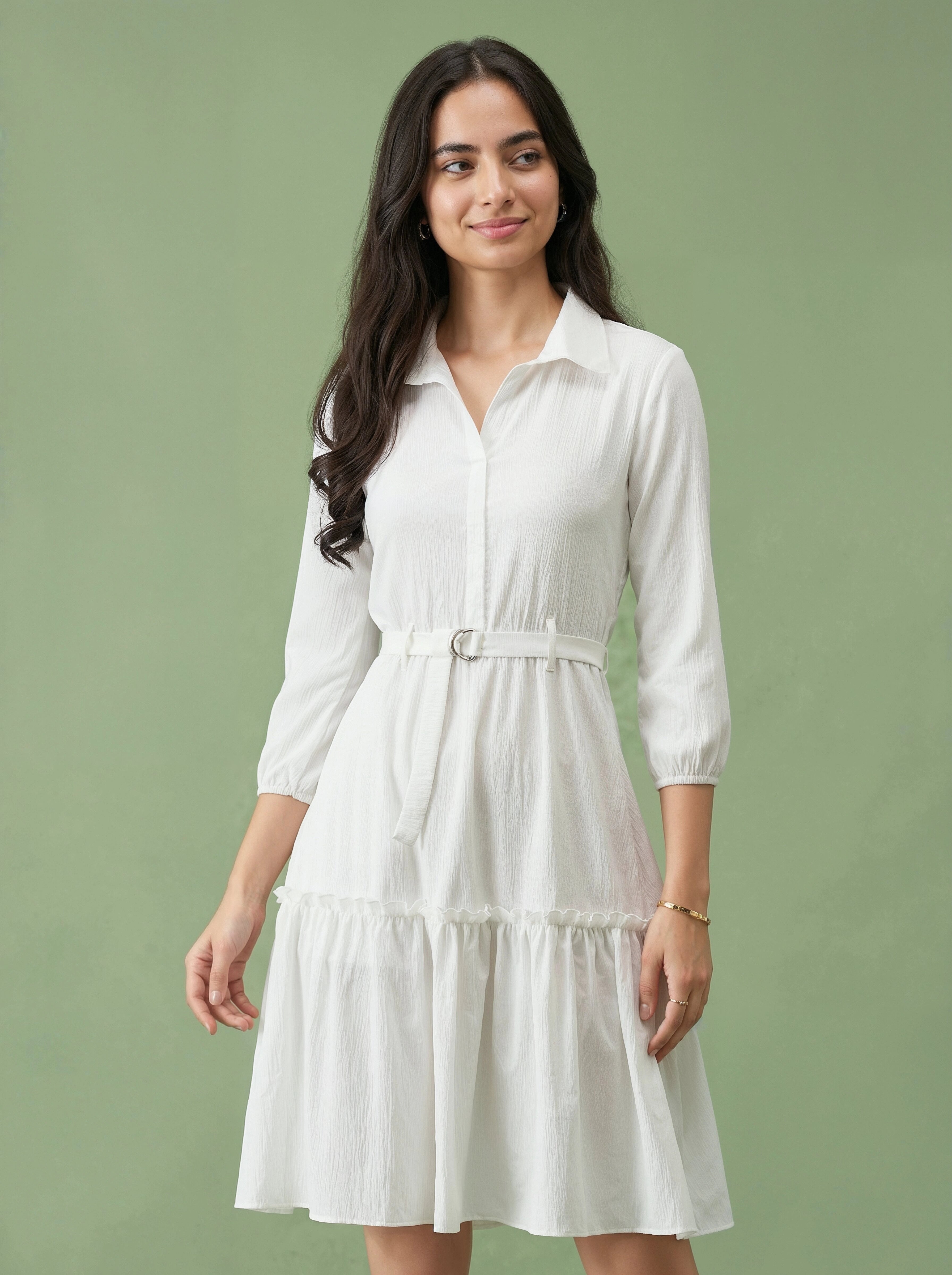 Woman wearing a white dress against a green background