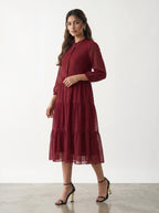 Woman wearing a red dress against a white background