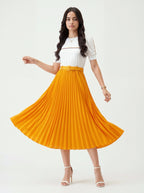 Woman wearing a white top and yellow pleated skirt on a white background