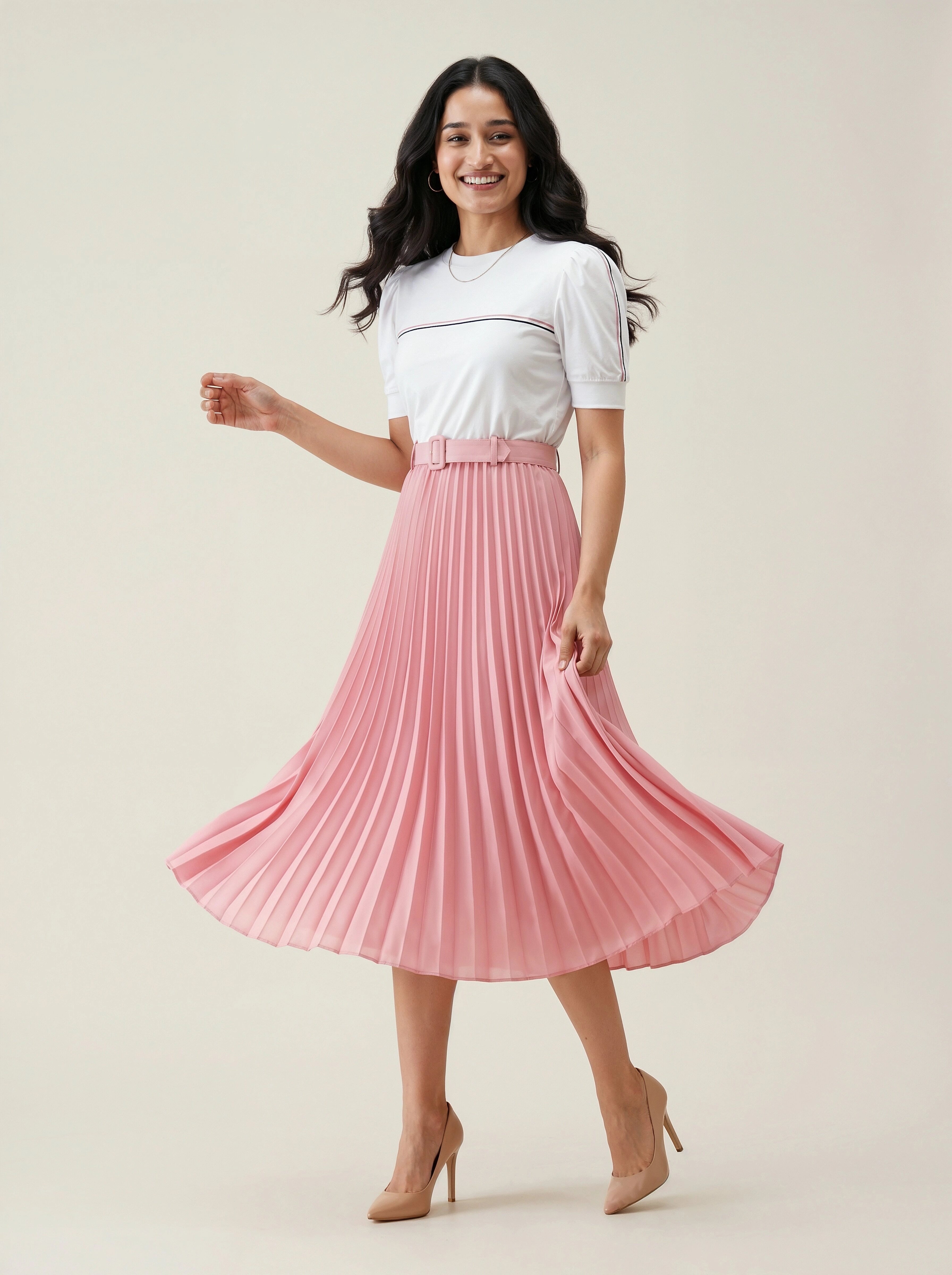 Woman wearing a white top and pink pleated skirt on a beige background