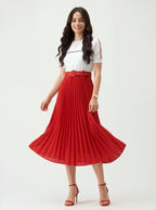 Woman wearing a white top and red pleated skirt on a white background