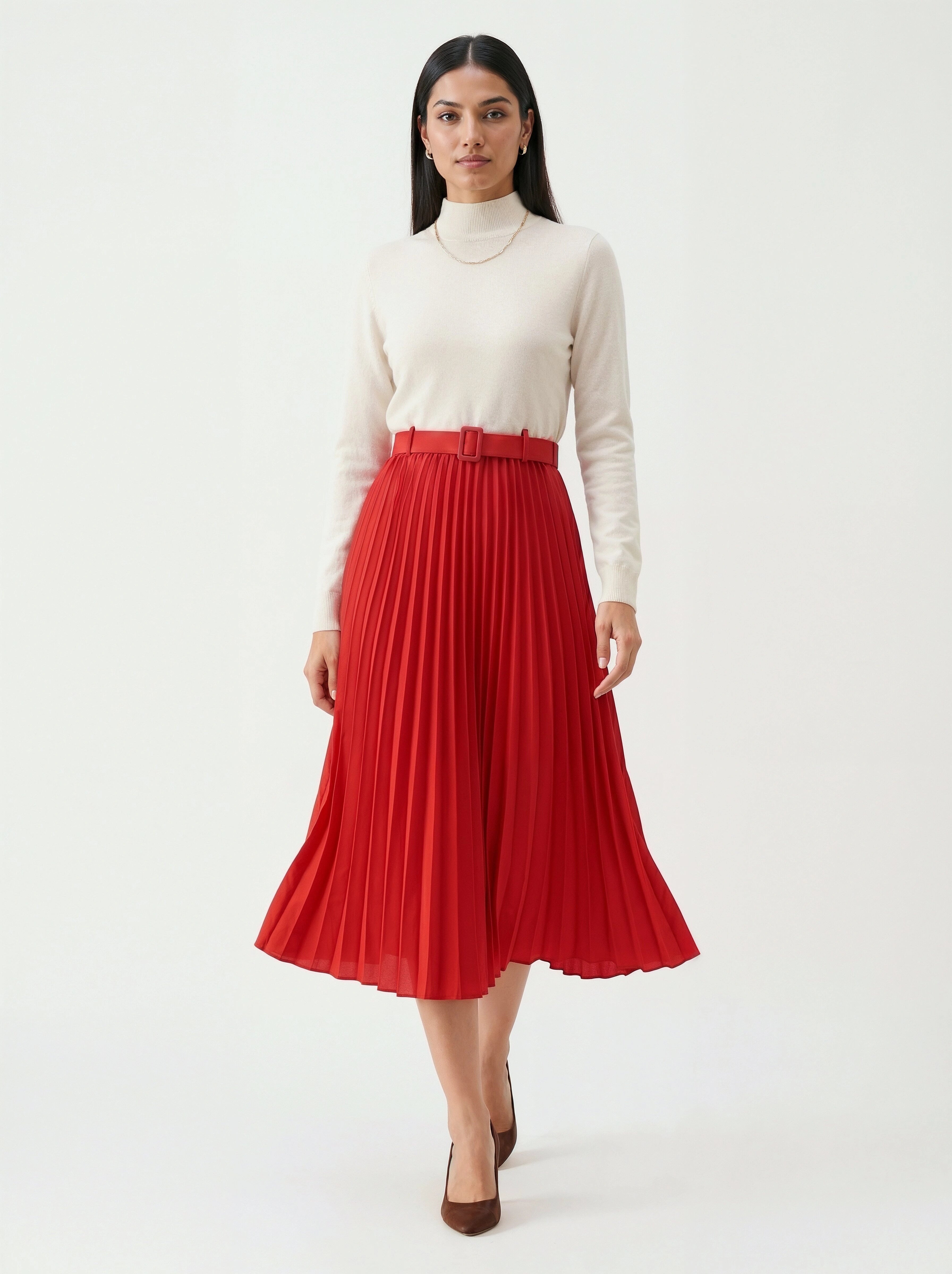 Woman wearing a white turtleneck and red pleated skirt on a white background