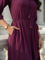 Person wearing a purple dress with a blurred background